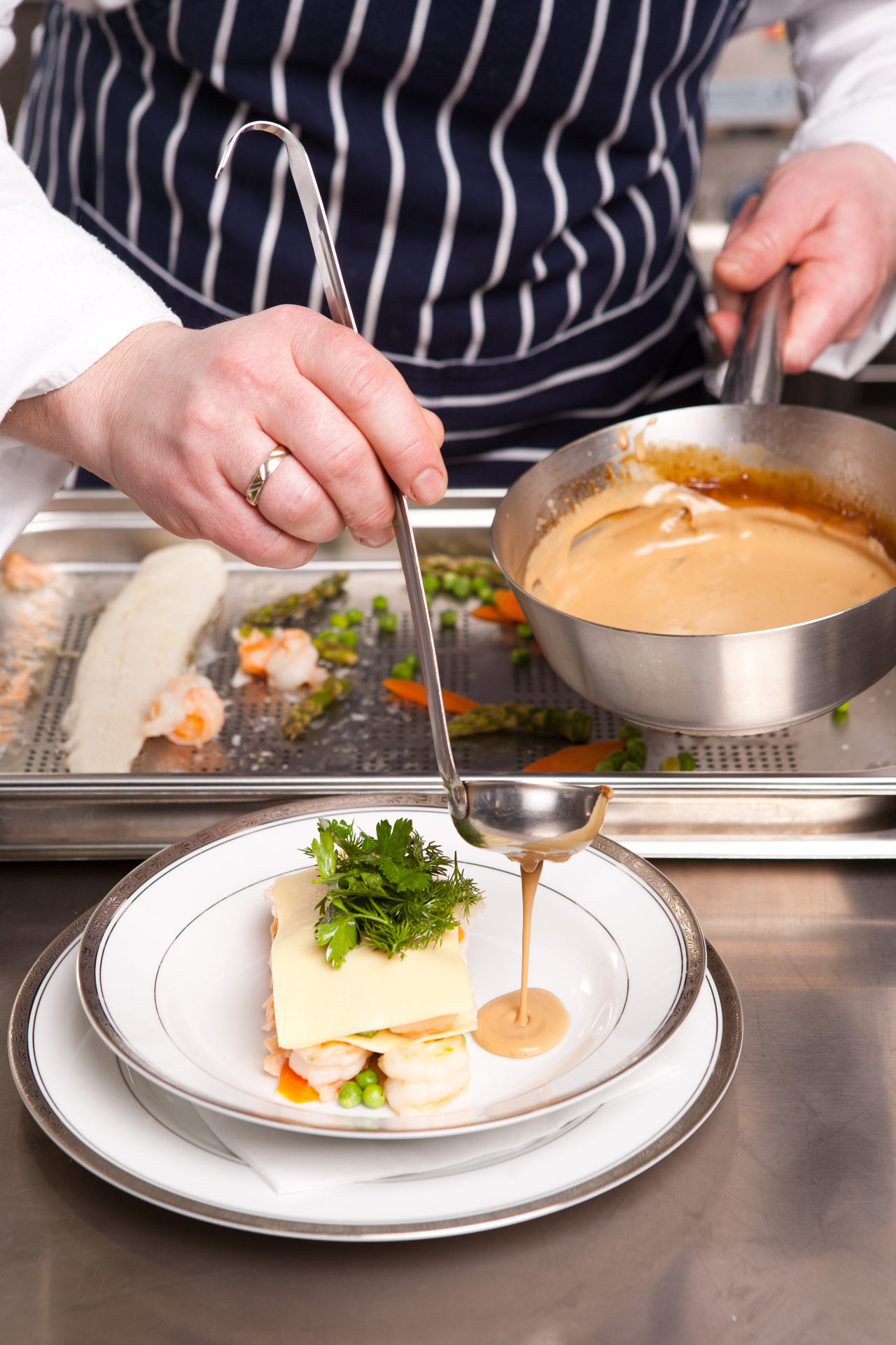 Chef cooking seafood lasagna