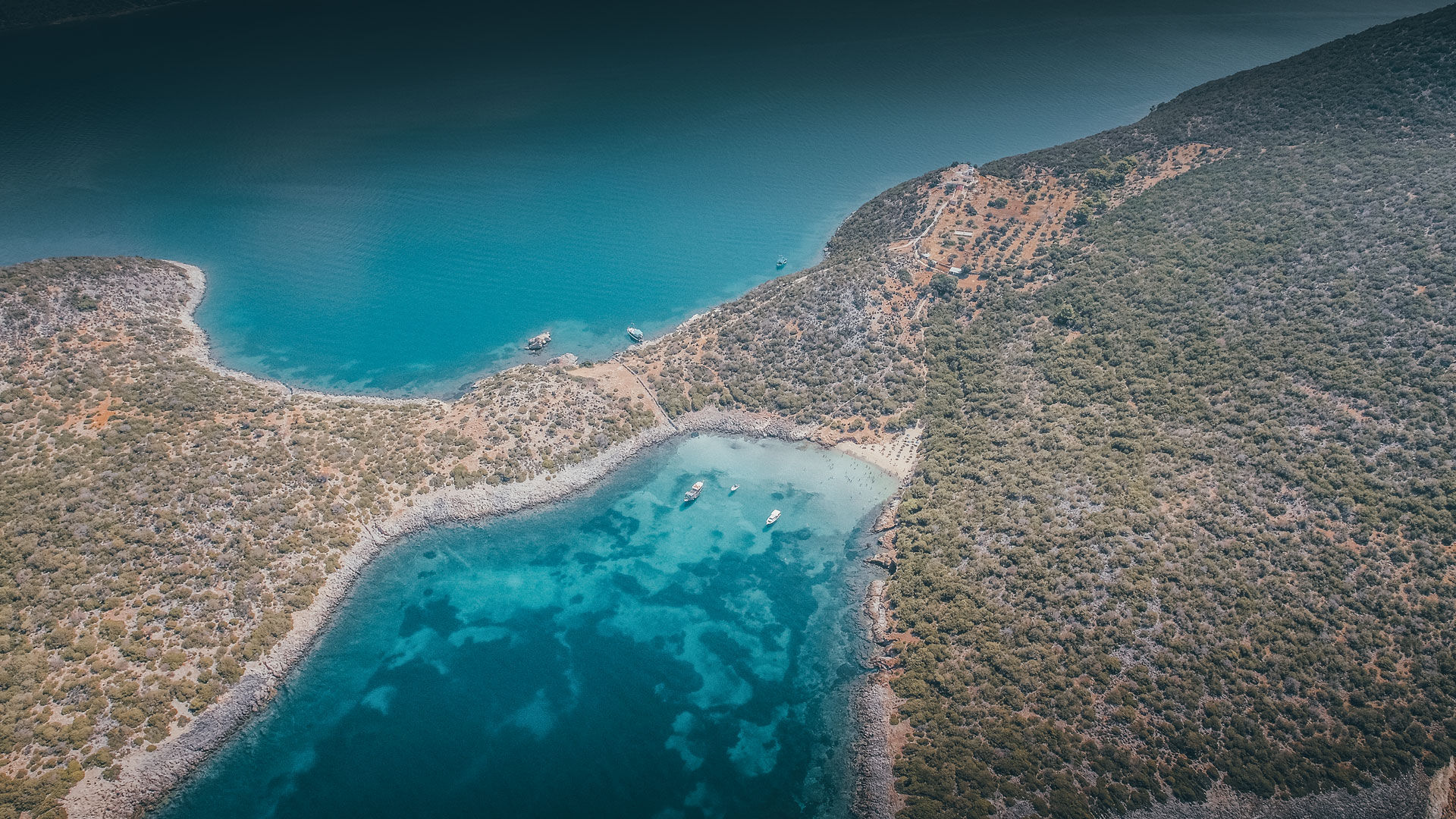 You’ll find a few buildings, among them the chapels of Agia Pelagia and the Ascension of Christ, and another, even smaller beach