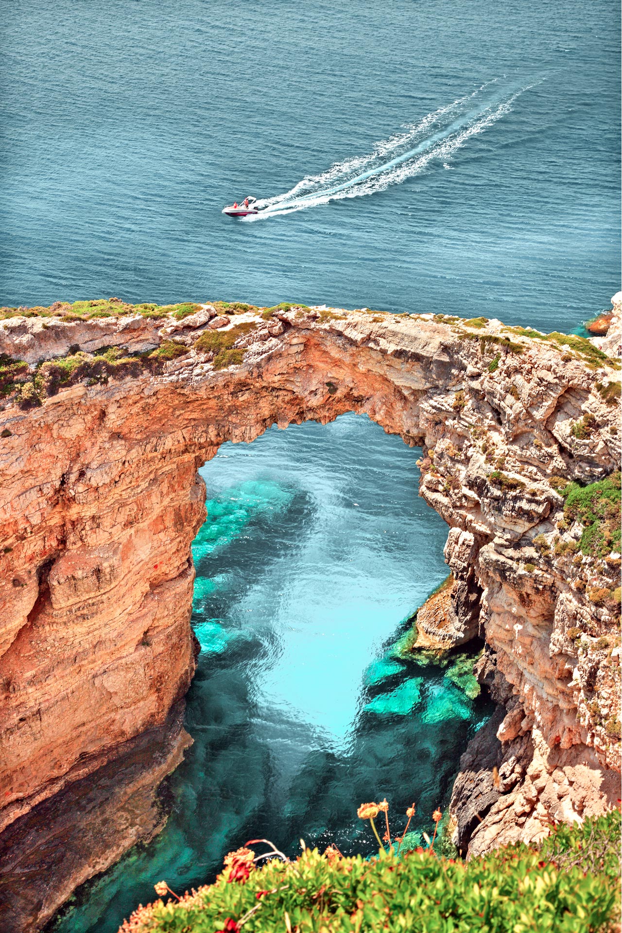 Boat passing next to Trypitos (also known as Kamara), a natural rocky arch at Paxos island