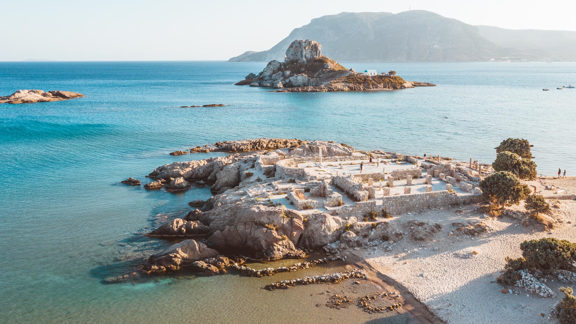 It’s not just the natural beauty of Agios Stefanos beach, but the tiny rock of an island opposite, called Kastri