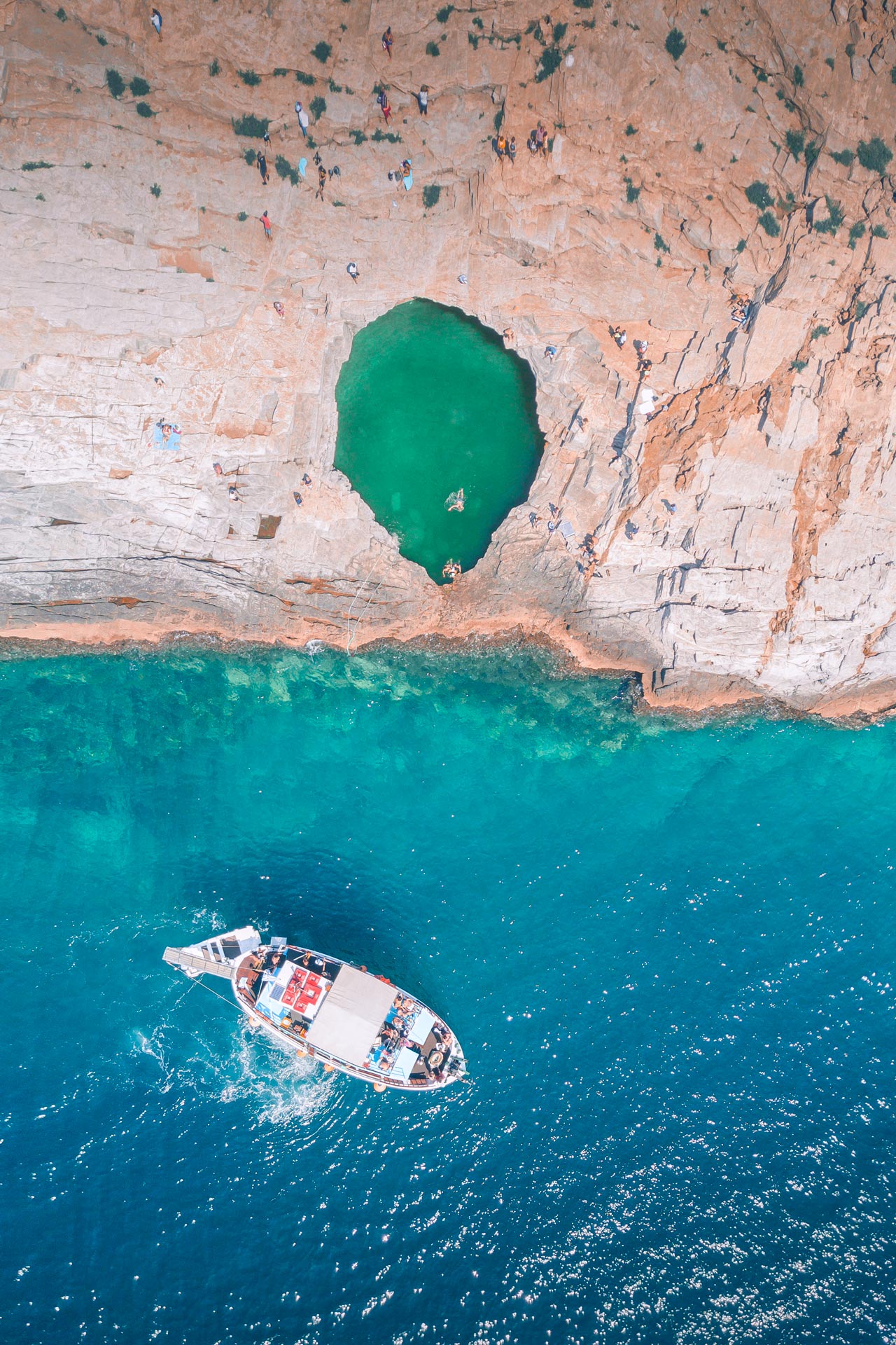 Approaching Giola natural rock pool by boat, Thassos island