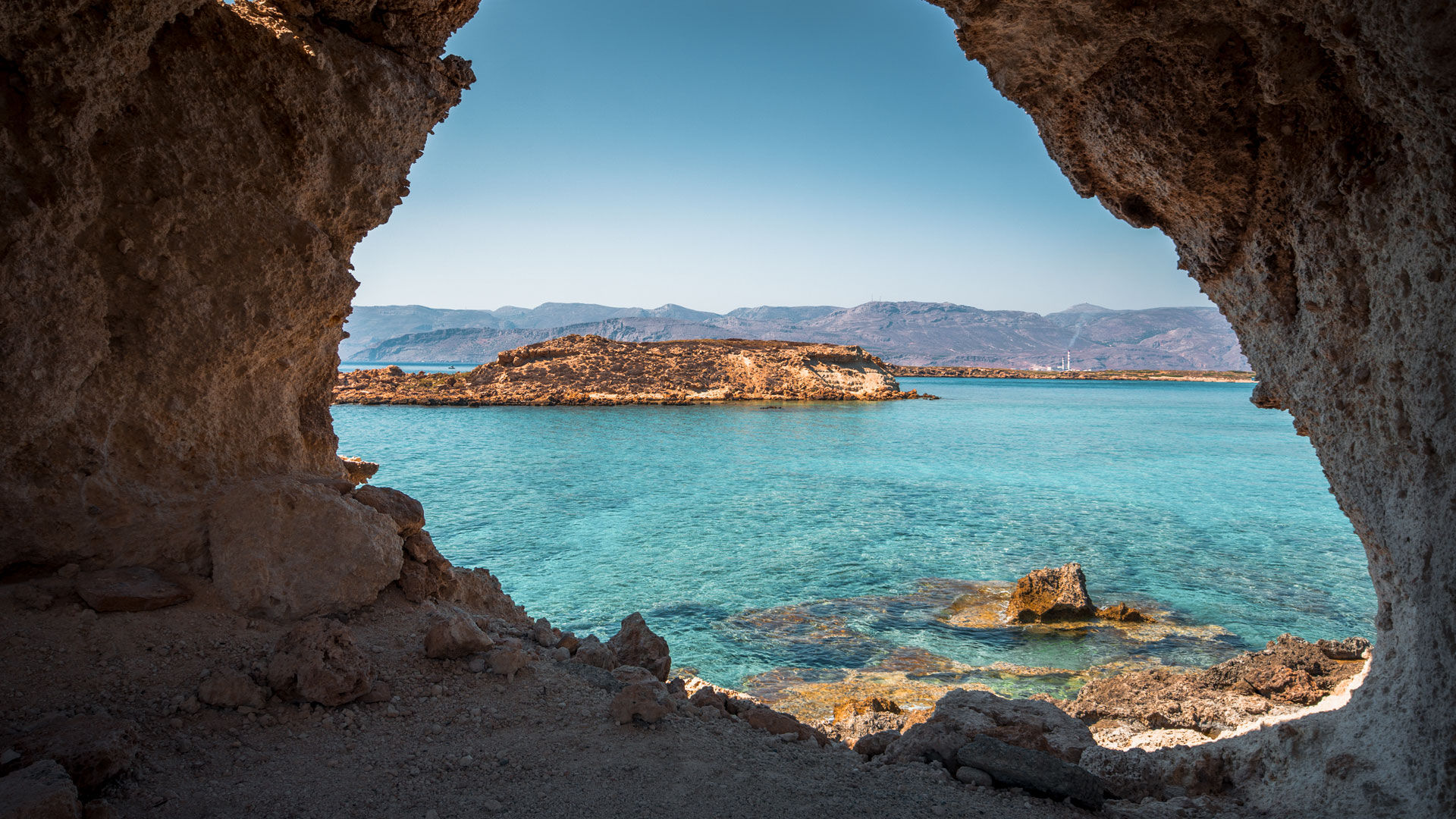 Amazing view through a cave of Koufonisi island with magical turquoise waters