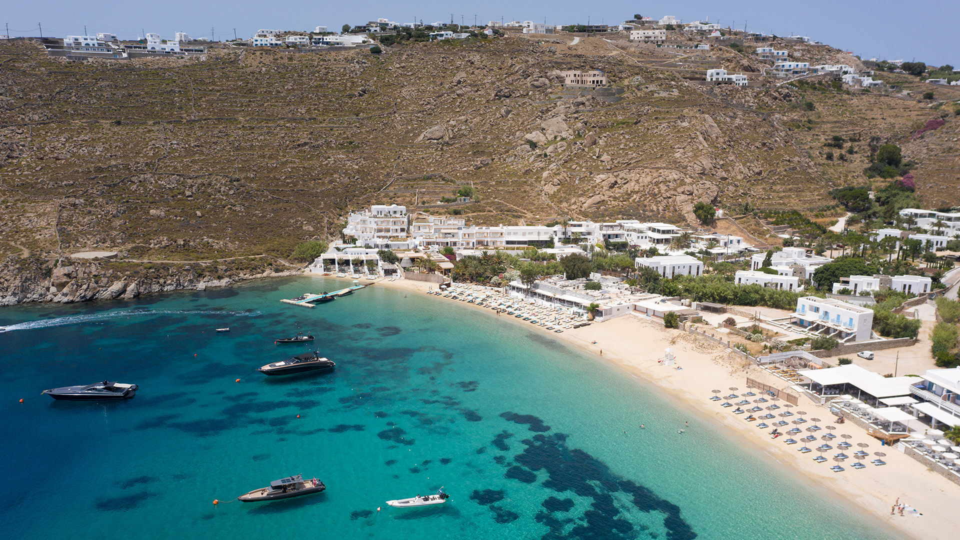 Legendary Psarou beach in Mykonos in early summer months.