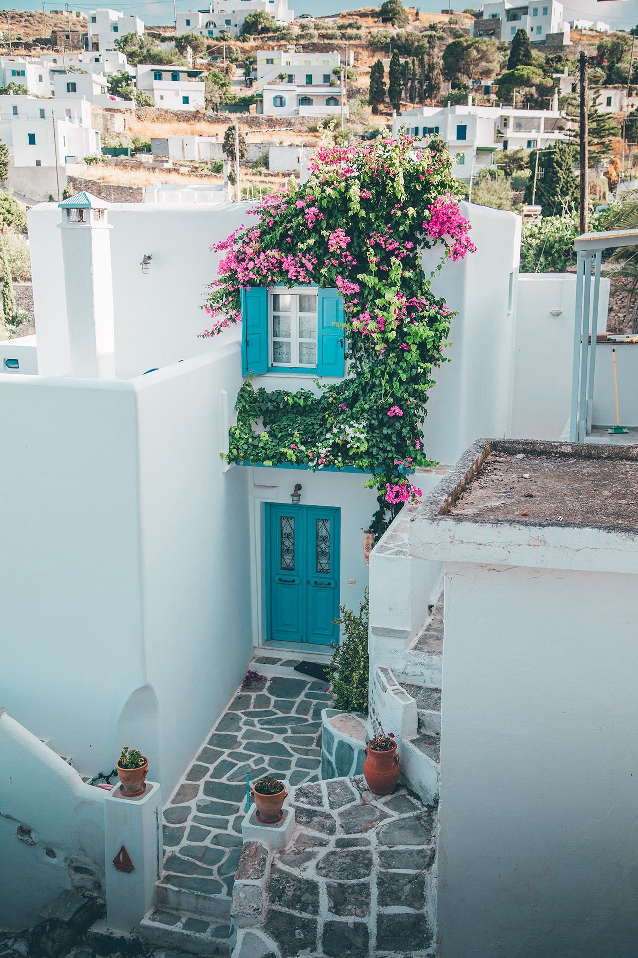 In Lefkes vilage you will find whitewashed houses, blue doors, bougainvillea and windmills