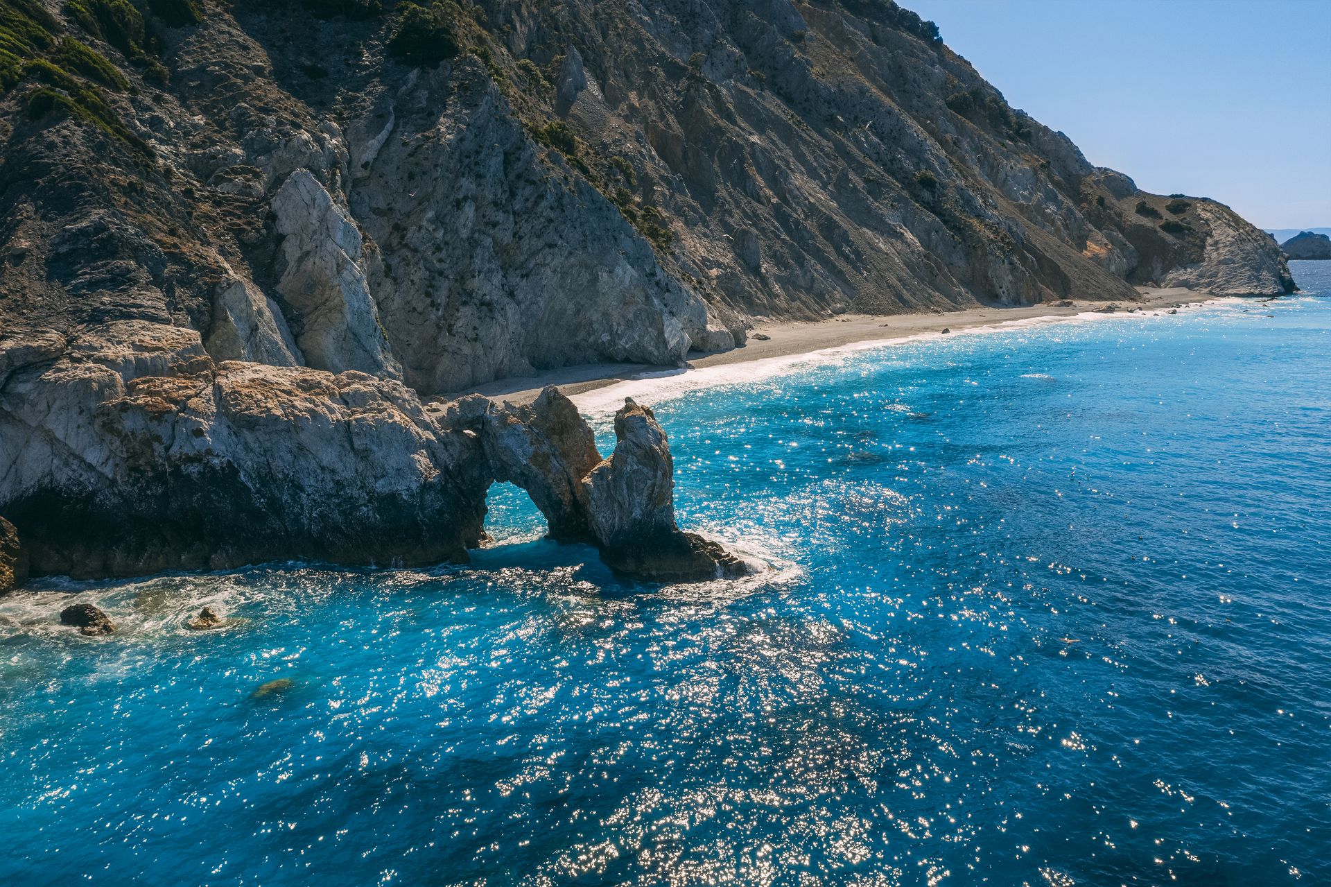 Lalaria, up on the north coast of Skiathos is unique for its smooth, pearly-white pebbles and dramatic cliff setting