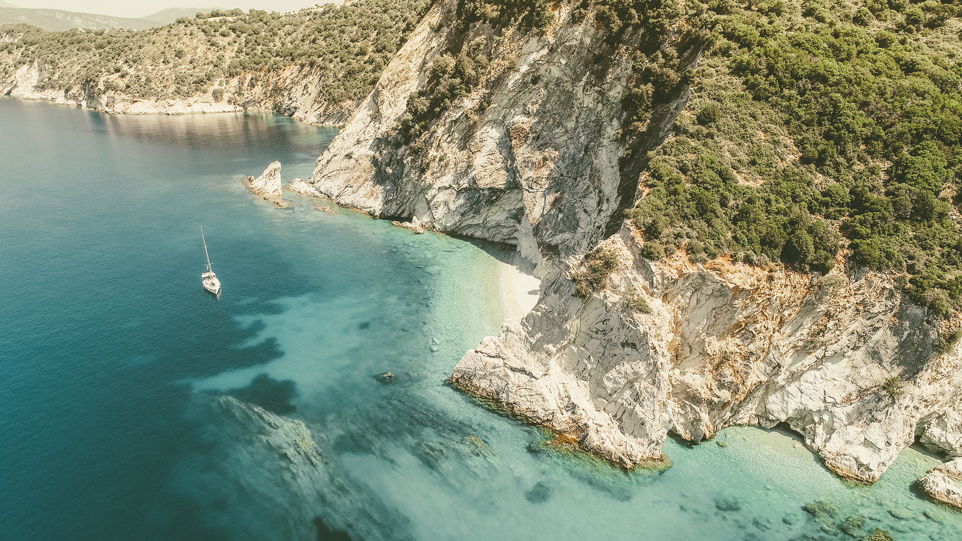 Meganisi, a green speech mark-shaped island off the south coast of Lefkada