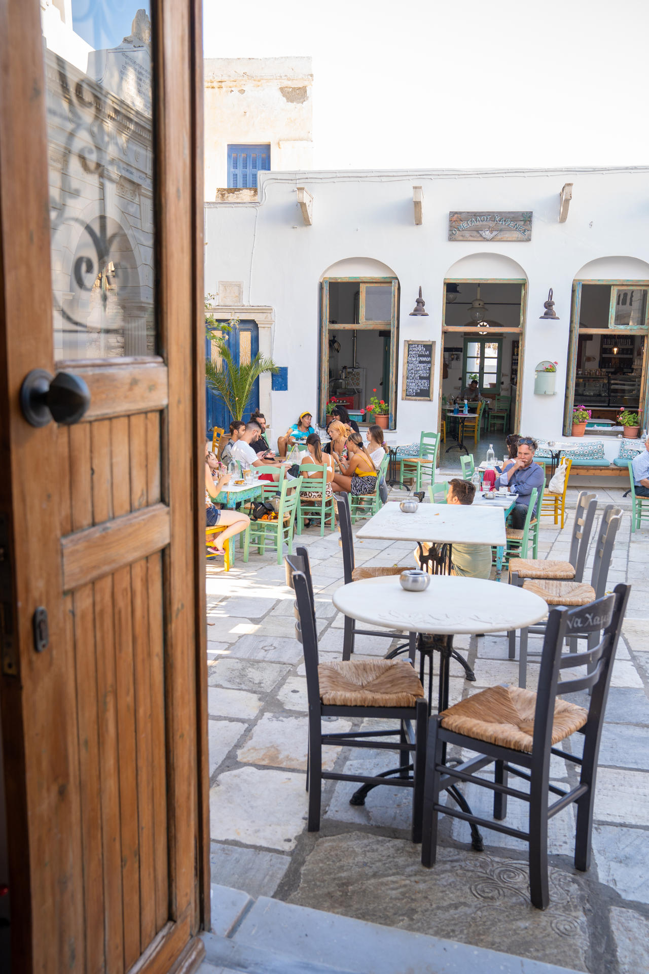 Pyrgos (also known as Panormos), in the north, has a charming square where you can settle down to Greek coffee and a slice of galaktoboureko