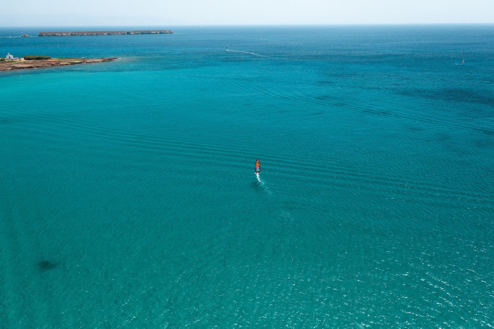 Chrissi Akti beach has facilities for both beginner and advanced windsurfers in Paros
