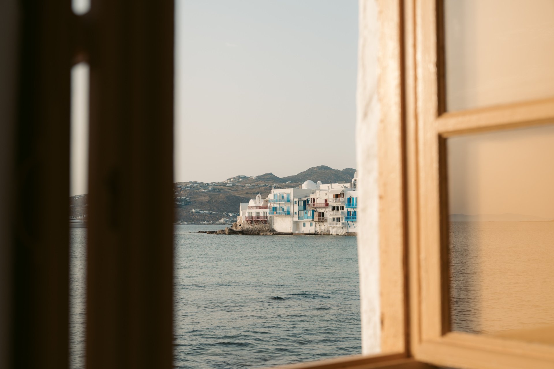 View of Mykonos through a balcony window