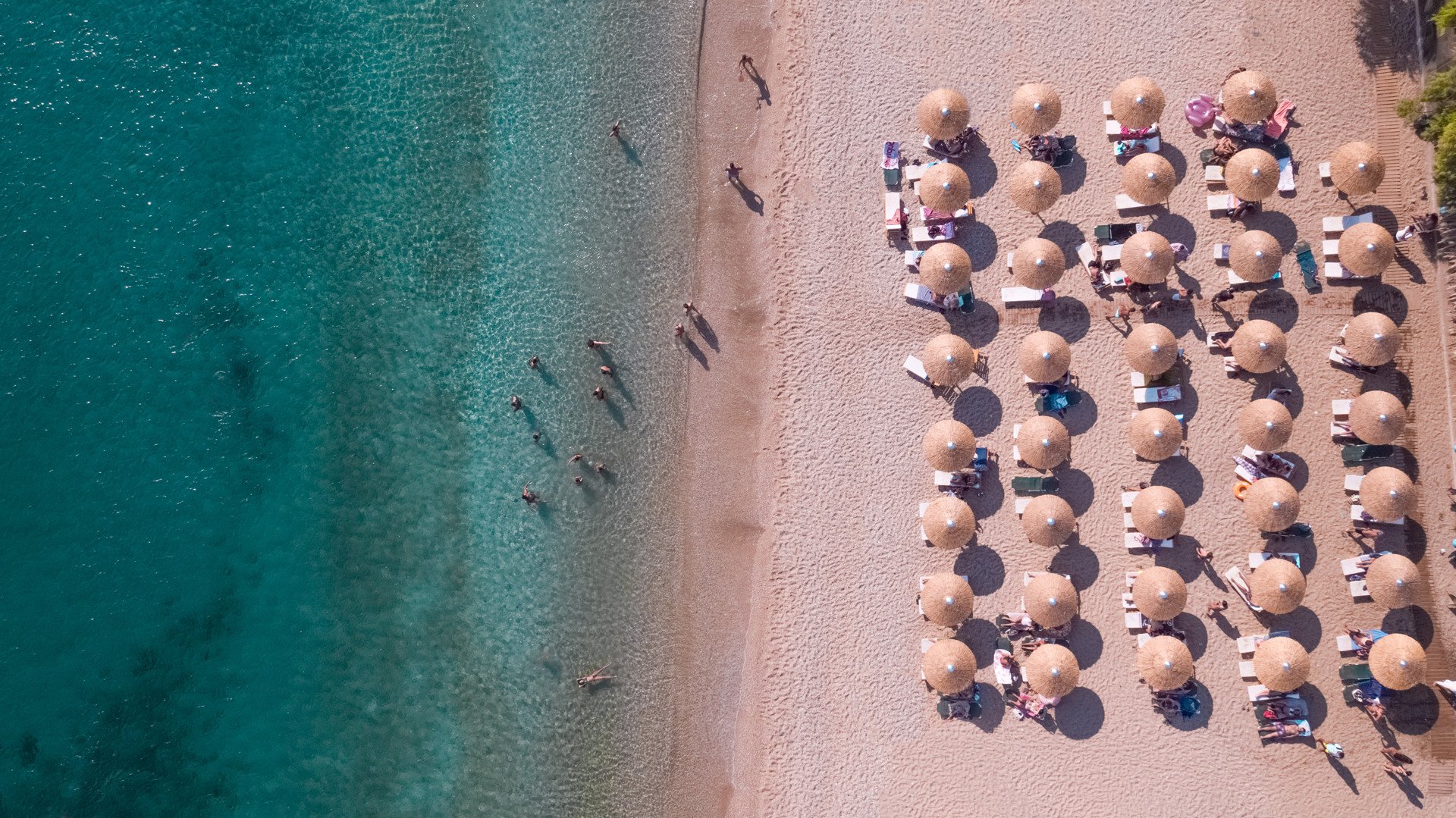 Agios Isidoros has pockets of sunbeds and umbrellas and beautiful clear water