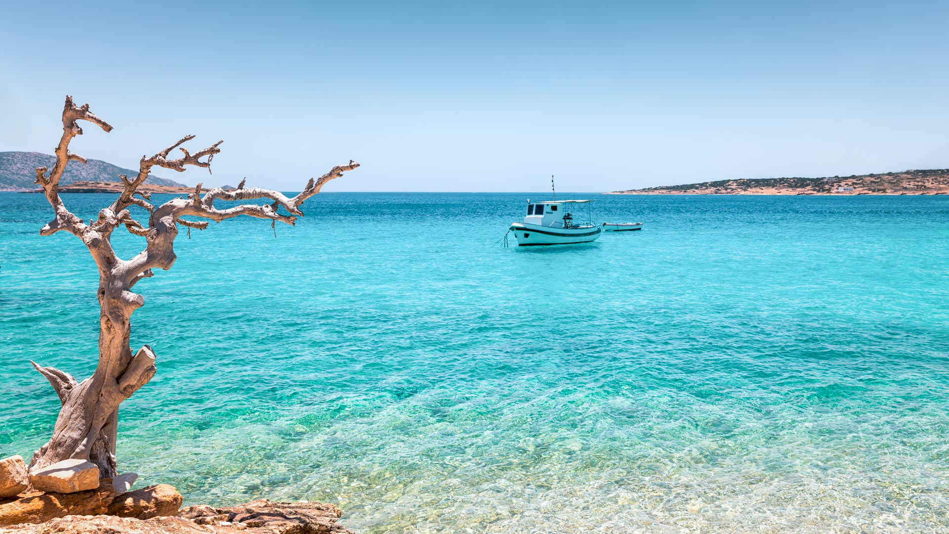 Fishing boat on turquase waters on Koufonisi