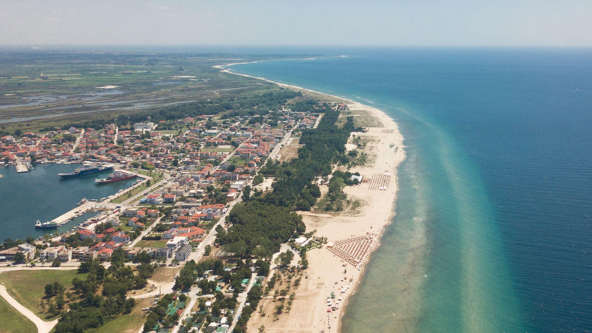 Long and sandy Keramoti beach has shallow, green-blue water that’s ideal for kids