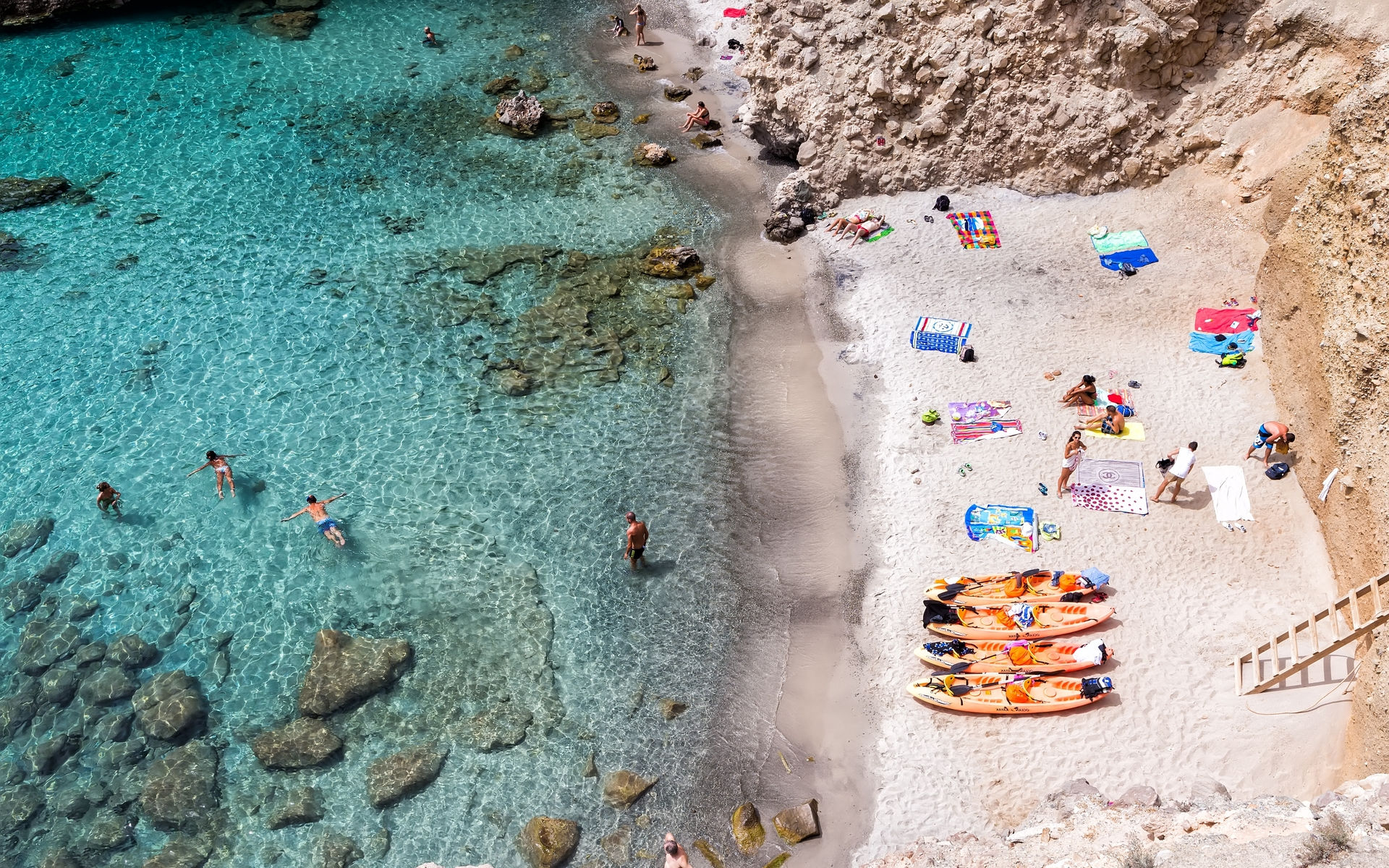 Milos, Greece - September 10, 2015: Top view of canoes at Tsigrado Beach in Milos island, Cyclades,