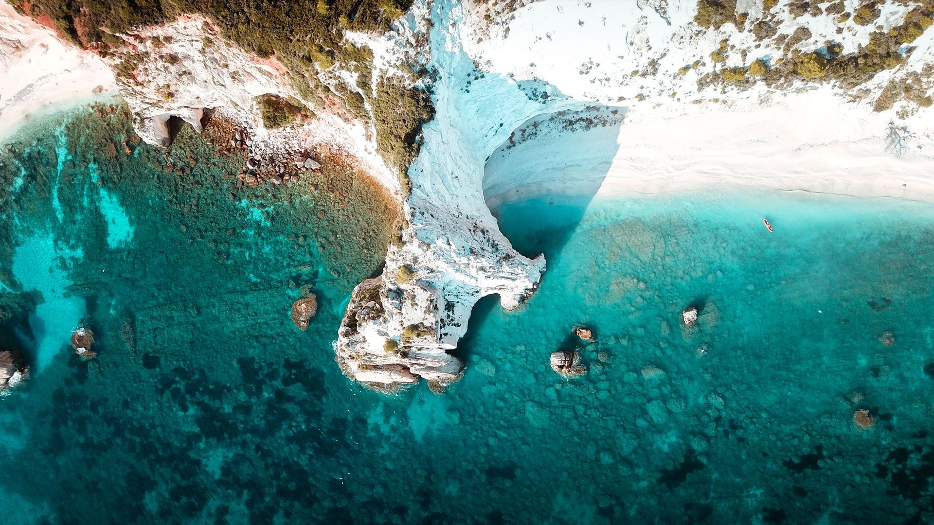 Iconic white rock cliffs and volcanic formations near the famous beach of Platys and Makrys Gialos