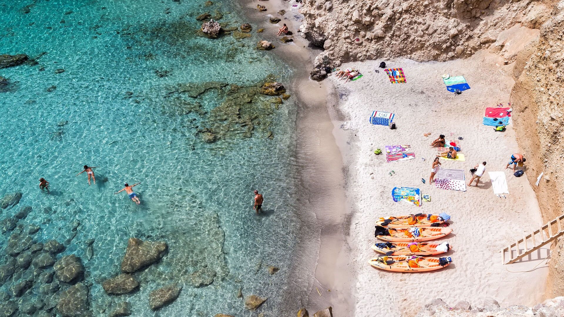 Milos, Greece - September 10, 2015: Top view of canoes at Tsigrado Beach in Milos island, Cyclades,