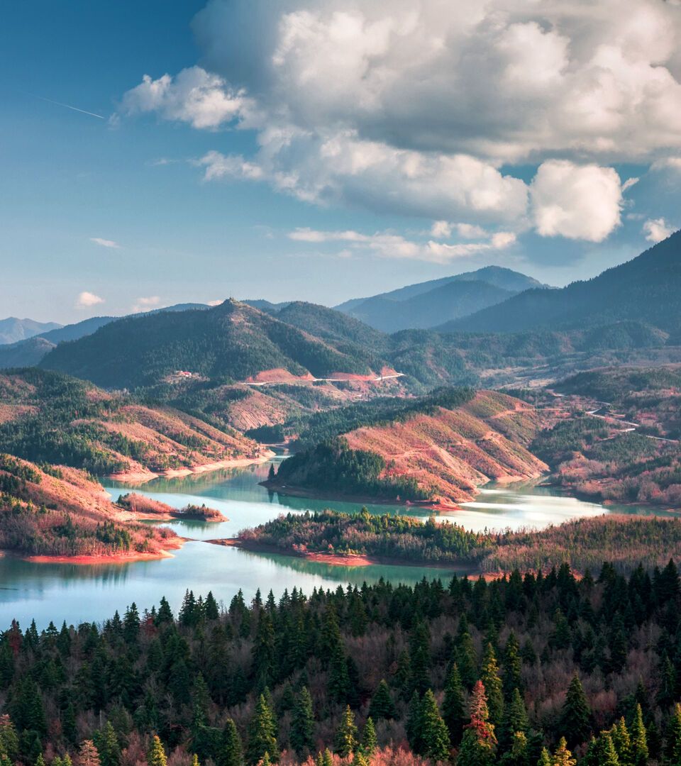 The beauty of its waters, reflecting the imperious peaks of the Agrafa range