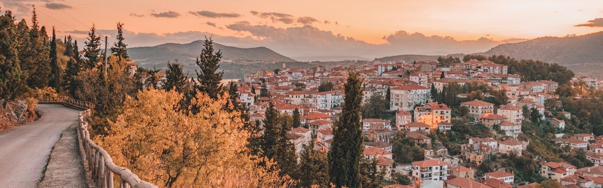 Scenic view of Kastoria town and the famous Orestiada lake in fall season against a cloudy sky