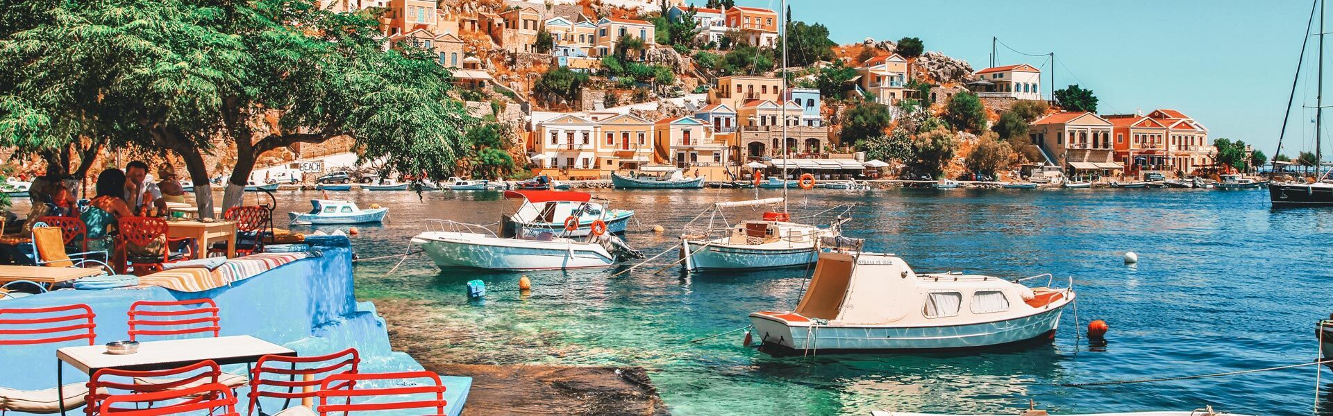 Take a look around you… at the generously-laid out tavernas and those houses rising theatrically up the hillside towards the Upper town