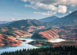 The beauty of its waters, reflecting the imperious peaks of the Agrafa range