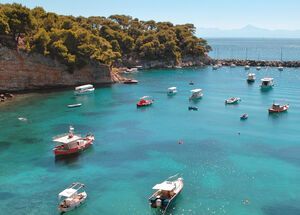 Small boats moored in the harbour of Votsi fishing village