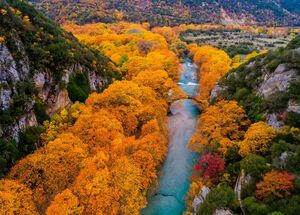 Aerial view of the Old stone bridge in Klidonia Zagoria in the autumn, Epirus, Western Greece. This arch bridge with elongated arch built in 1853.