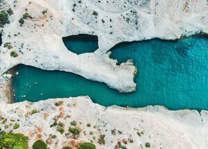 Papafragas caves, with a little sandy beach at one end