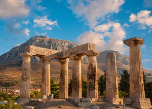 Ruins of Appollo temple with fortress at back in ancient Corinth