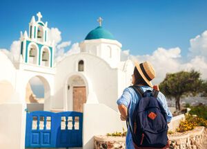 Santorini island traveler exploring greek church architecture in Akrotiri