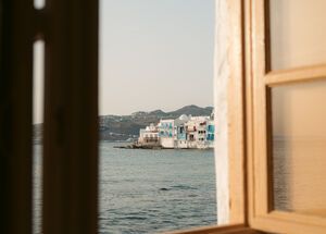 View of Mykonos through a balcony window