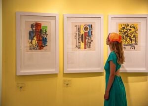 Visitor viewing framed artworks at the Stratis Eleftheriades-Tèriade Museum and Library, Lesvos