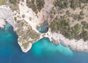corinthia-full-day-canyoning-in-pissia-gorge-coastal-hike-to-seal-cave-with-swimming-logo