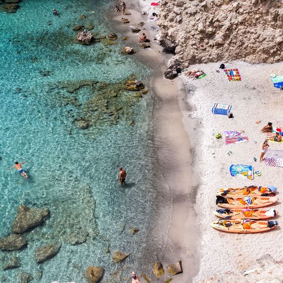 Milos, Greece - September 10, 2015: Top view of canoes at Tsigrado Beach in Milos island, Cyclades,