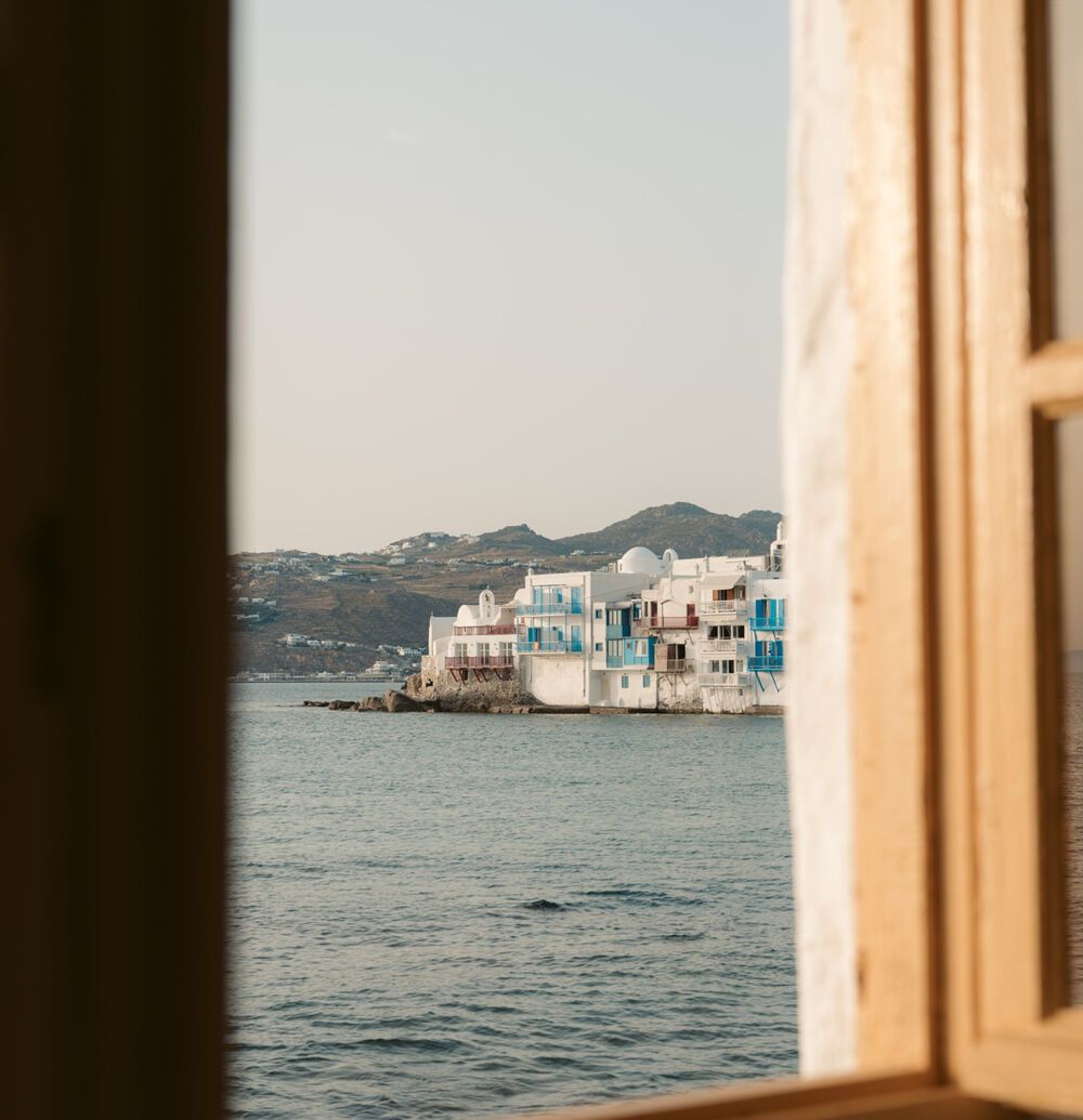 View of Mykonos through a balcony window