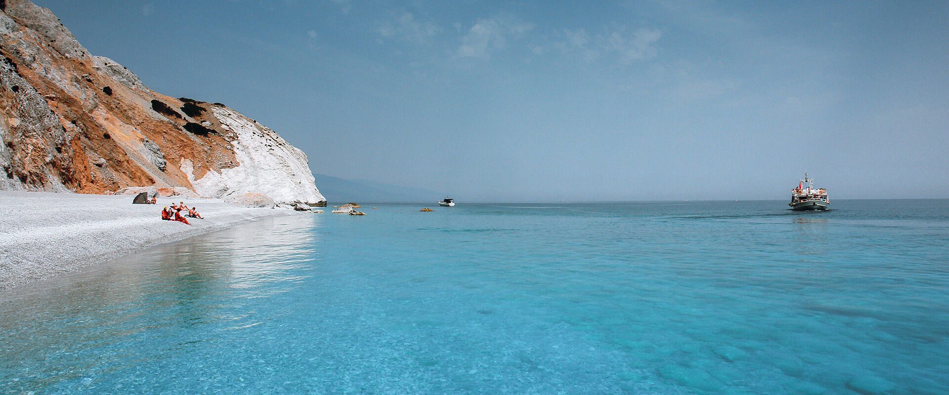 Lalaria’s unique shiny pebbles and other-worldly setting make for an unforgettable day trip