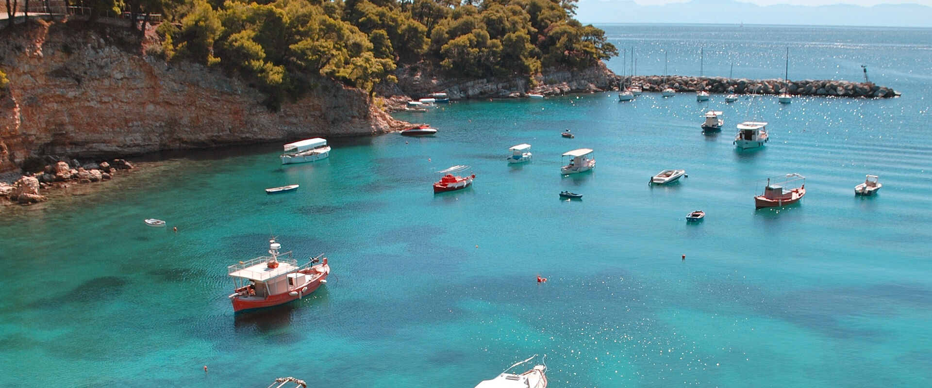 Small boats moored in the harbour of Votsi fishing village