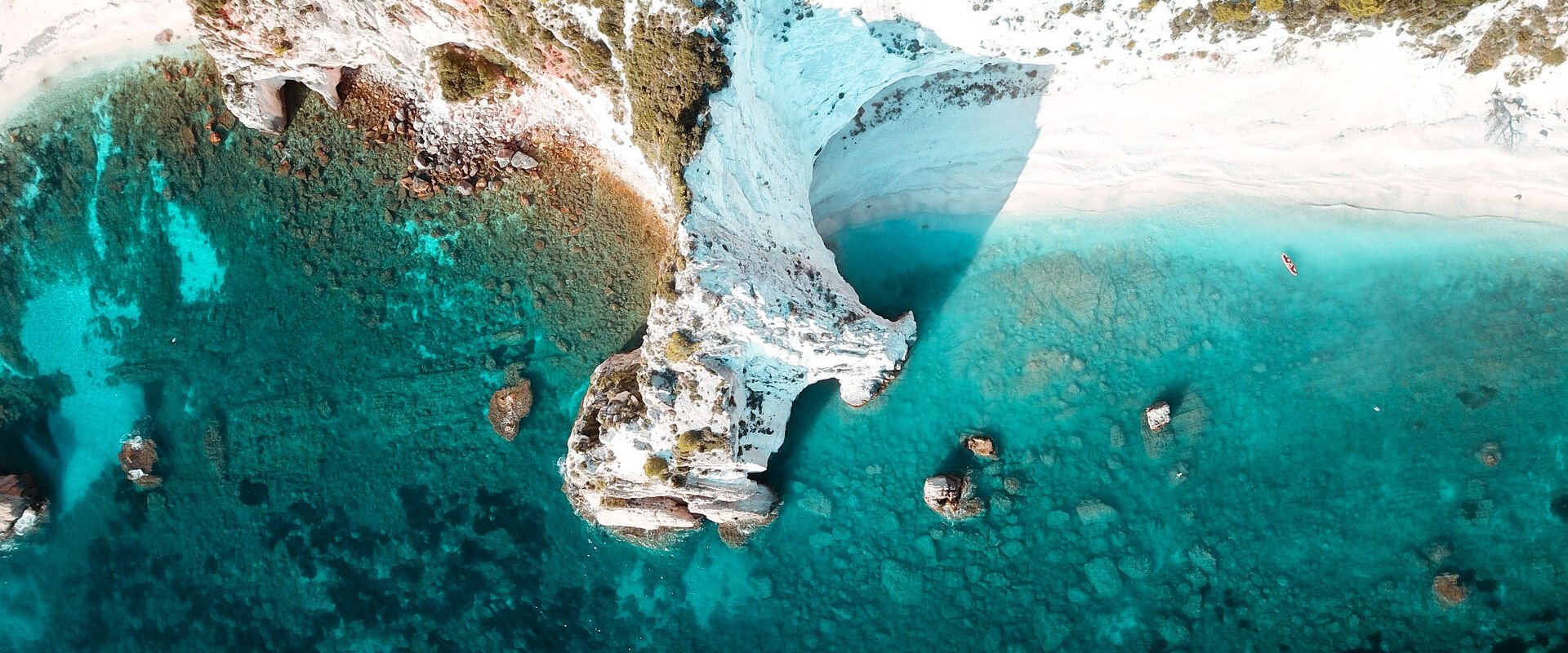 Iconic white rock cliffs and volcanic formations near the famous beach of Platys and Makrys Gialos