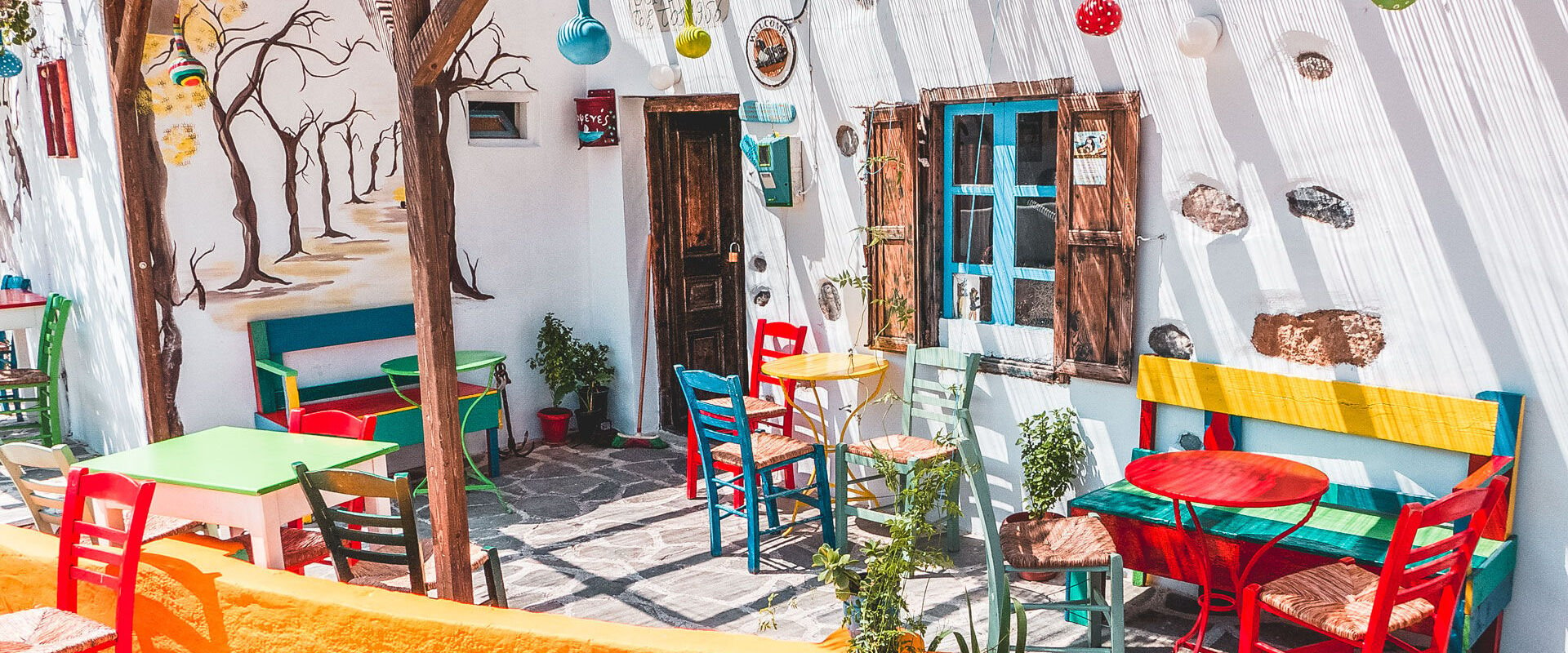 Whitewashed houses, blue windows, flowery courtyards and colorful cafes in Maltezana village, Astypalea
