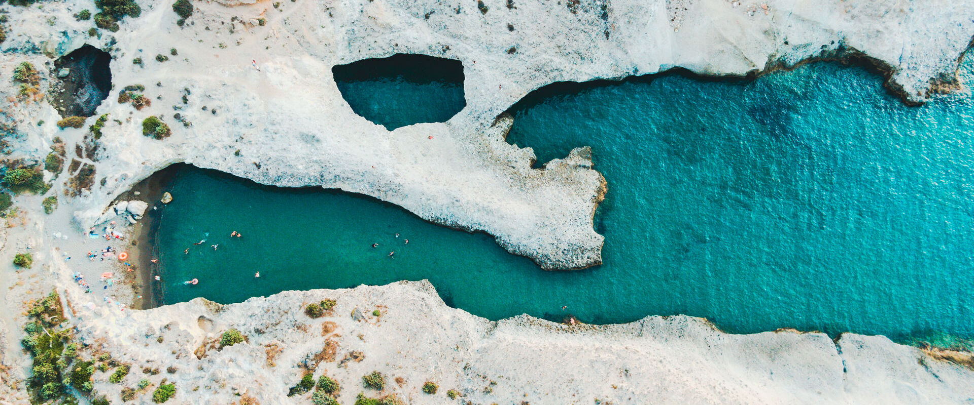 Papafragas caves, with a little sandy beach at one end