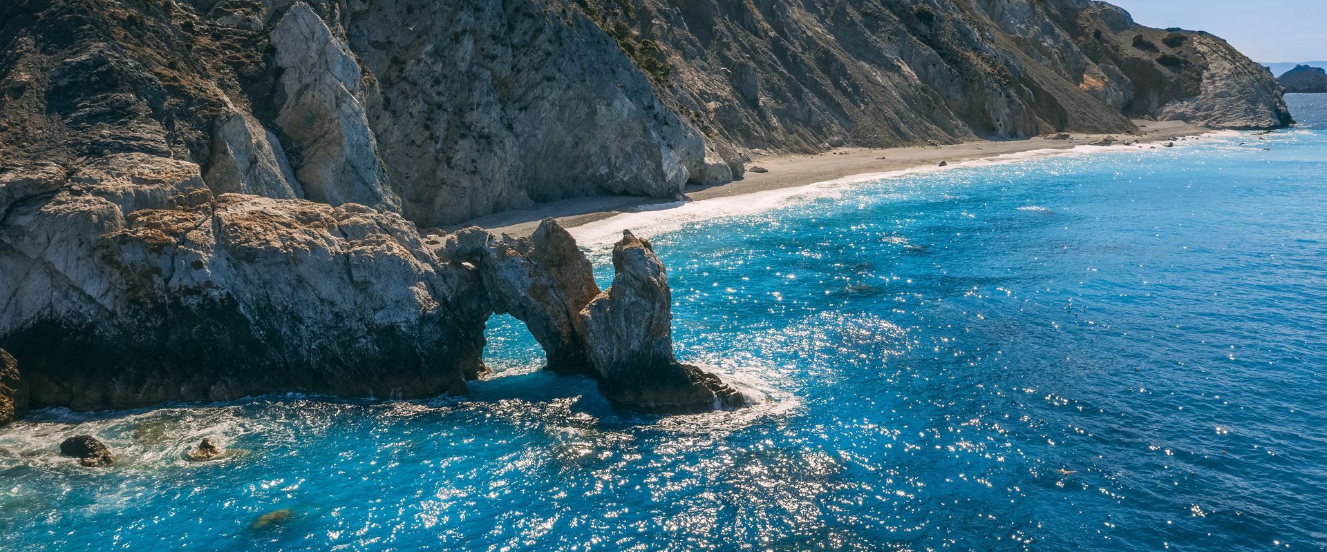 Lalaria, up on the north coast of Skiathos is unique for its smooth, pearly-white pebbles and dramatic cliff setting