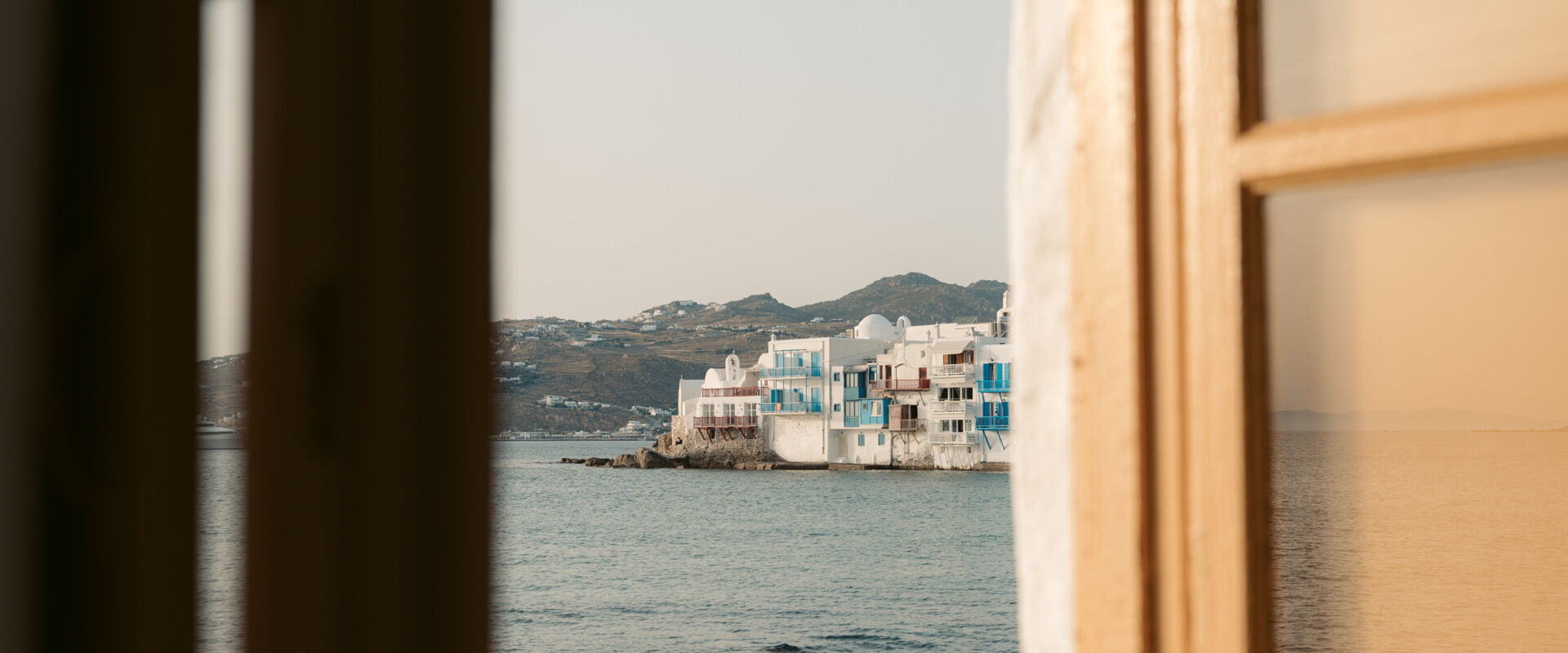 View of Mykonos through a balcony window