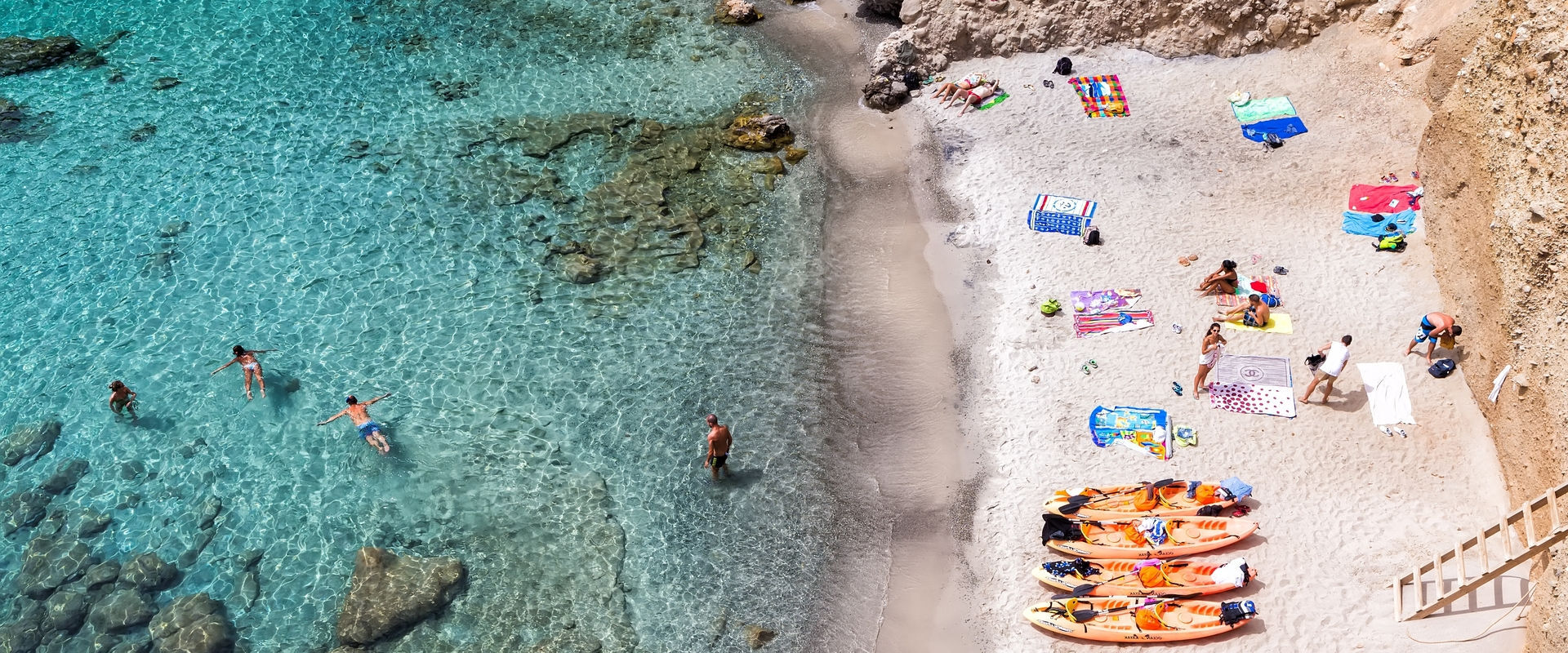 Milos, Greece - September 10, 2015: Top view of canoes at Tsigrado Beach in Milos island, Cyclades,
