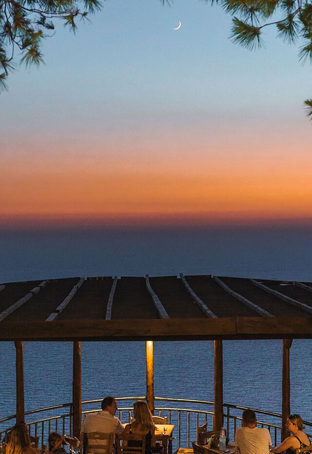 Near Keri village, eating a romantic dinner-for-two at a taverna high up on the cliffs.