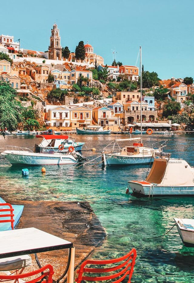 Take a look around you… at the generously-laid out tavernas and those houses rising theatrically up the hillside towards the Upper town