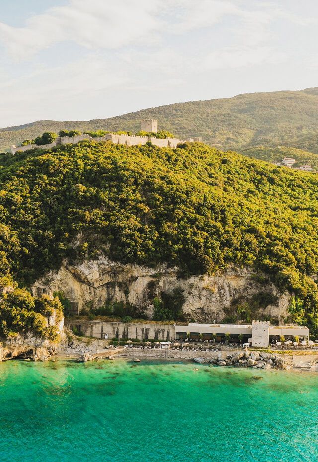 A beach with a castle and mountain-view 