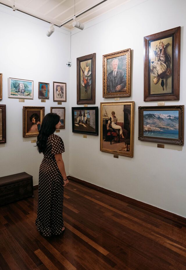 Visitor viewing paintings inside the Municipal Art Gallery of Mytilene, Lesvos