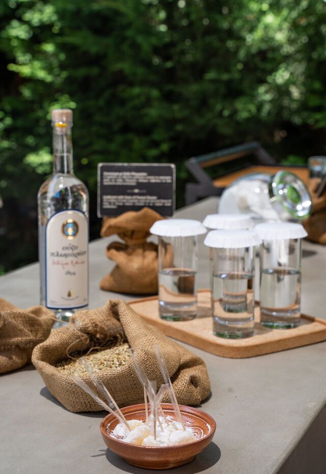 Ouzo tasting setup with bottle and glasses at the Museum of Ouzo Plomari, Lesvos