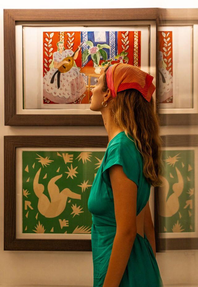 Visitor admiring framed prints in the Stratis Eleftheriades-Tèriade Museum and Library, Lesvos
