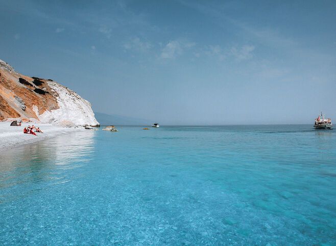 Lalaria’s unique shiny pebbles and other-worldly setting make for an unforgettable day trip