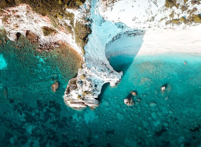 Iconic white rock cliffs and volcanic formations near the famous beach of Platys and Makrys Gialos