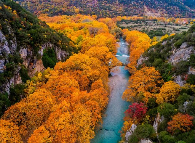 Aerial view of the Old stone bridge in Klidonia Zagoria in the autumn, Epirus, Western Greece. This arch bridge with elongated arch built in 1853.